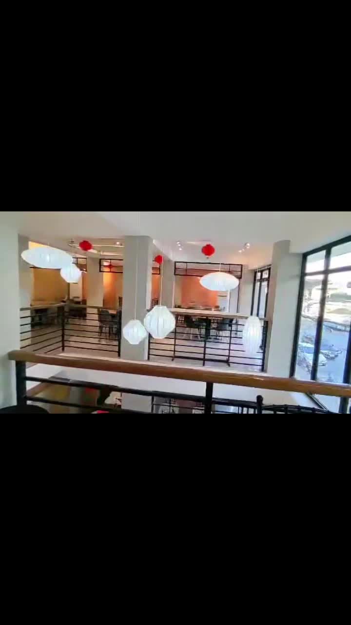 Huang's Cafe second floor — white lanterns, open dining hall with street view